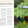 A spread from "Stained Glass for Beginners" by Schiffer Publishing, Ltd. shows step-by-step copper foil instructions on one side and a photo of a vibrant geometric stained glass mobile hanging outdoors on the other.