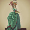 Illustration of a woman in an elaborate teal dress and floral hat holding a fan. The card, labeled 2 and Main Female, is from the Kipper Oracle Cards by Schiffer Publishing, Ltd., inspired by German divination cards.