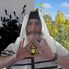 A bearded man in a white and black shawl holds a Hebrew-inscribed triangle, reflecting Kabbalah from the Rota Mundi Tarot by Schiffer Publishing, Ltd.; black crows perch on the left, while sunflowers bloom under a blue sky on the right.