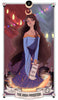 The Auset Gypsy Tarot by Schiffer Publishing, Ltd. features The High Priestess as a serene woman with long, wavy hair in a blue dress and crescent moon crown, holding a scroll among astrological symbols and stacks of books.