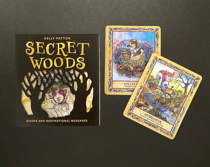 A box labeled Secret Woods by Schiffer Publishing, Ltd. sits on a dark surface next to two illustrated cards—Collector with a badger and Messenger with a fox on a bicycle—from this enchanting intuition card deck.