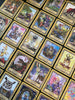 Secret Woods by Schiffer Publishing, Ltd. features illustrated intuition cards with whimsical animals, fantasy creatures, and mystical scenes—each bordered in gold with distinct labels and intricate artwork arranged on a surface.