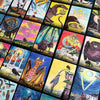 A spread of colorful Ravyness Drakon Tarot cards by Schiffer Publishing, Ltd. features birds, mythical creatures, and rich symbols. Each vivid card inspires self-awareness and comes with a detailed guidebook for deeper insight.