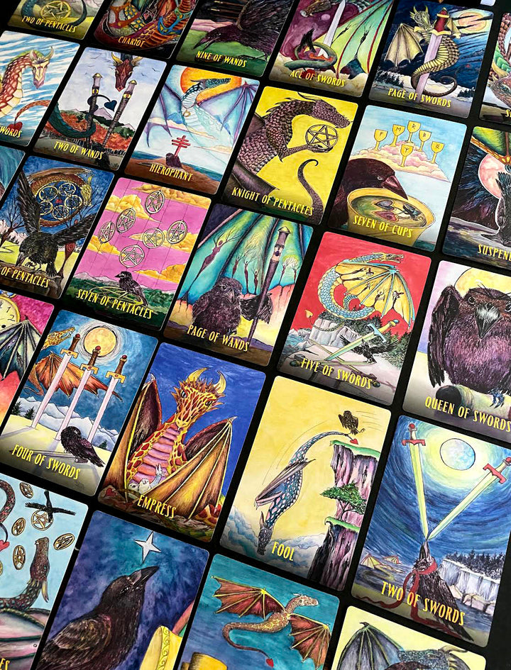 A spread of colorful Ravyness Drakon Tarot cards by Schiffer Publishing, Ltd. features birds, mythical creatures, and rich symbols. Each vivid card inspires self-awareness and comes with a detailed guidebook for deeper insight.