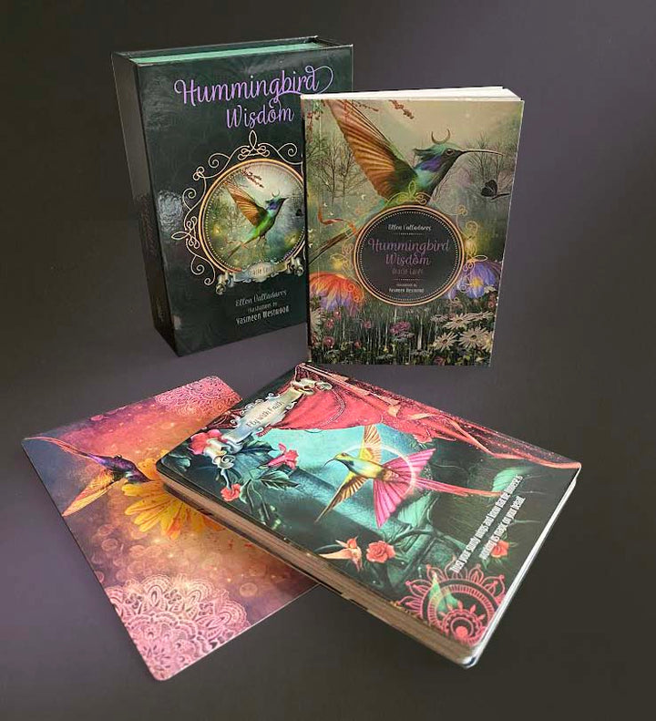 The Hummingbird Wisdom Oracle Cards by Schiffer Publishing, Ltd. are shown with their box, guidebook, and vibrant illustrated cards featuring hummingbirds and florals—a great choice for fans of mystical oracle decks.