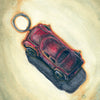 Illustration of a red toy car keychain on a muted background, with the number 2 in the top right and "CAR" in the bottom left, inspired by modern oracle decks. From Between the Worlds by Schiffer Publishing, Ltd.