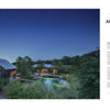 A modern farmhouse at night with a rustic barn, warmly lit main house, lush landscaping inspired by Private Gardens of the Potomac and Chesapeake from Schiffer Publishing, Ltd., plus a pool in the foreground beneath a starry sky.