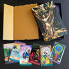 The Steele Wizard Tarot by Schiffer Publishing, Ltd. is shown on a black surface with its open patterned gold box, guidebook, and five illustrated cards: Six of Swords, Knight of Cups, Magician, Ten of Cups, and The Lovers.