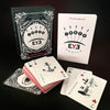 The Inner Eye Oracle by Schiffer Publishing, Ltd.—an illustrated oracle deck with symbols and keywords, spread out alongside its card box and guidebook on a black background—offers inspiration for your spiritual journey.