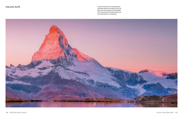 The Wild Alps from Schiffer Publishing, Ltd. captures the snow-capped Matterhorn glowing pink at sunrise, reflected in a calm alpine lake—showcasing clear skies, soft hues, and the dramatic landscapes of the Valais Alps.