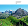 Experience breathtaking panoramas from The Wild Alps by Schiffer Publishing, Ltd., featuring vivid green hills and rugged peaks beneath clear blue skies—ideal for any photo book celebrating spectacular Alpine landscapes.