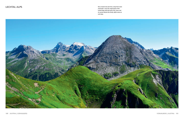 Experience breathtaking panoramas from The Wild Alps by Schiffer Publishing, Ltd., featuring vivid green hills and rugged peaks beneath clear blue skies—ideal for any photo book celebrating spectacular Alpine landscapes.