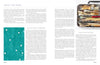 An open spread of "The Cumulative Cloth, Wet Techniques" by Schiffer Publishing, Ltd. shows the book’s organization, a teal abstract art with white dots on the left page, and assorted paintbrushes inspiring fabric surface design in the corner.