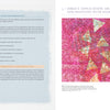 A book spread from "The Cumulative Cloth, Wet Techniques" by Schiffer Publishing, Ltd. shows fabric surface design and art techniques text on the left, and a vivid pink and gold abstract mixed media artwork with triangles and swirls on the right.