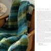 A striped knit blanket from "Nordic Hands" by Schiffer Publishing, Ltd. is draped over a woven chair next to a table with pastries and coffee. The page includes an introductory text about Scandinavian culture.