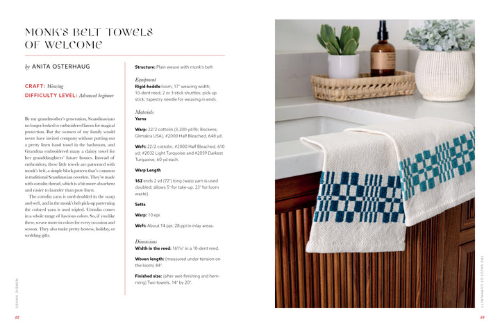 Two Nordic Hands towels by Schiffer Publishing, Ltd.—white with blue Scandinavian-inspired geometric patterns—hang on a wooden kitchen drawer near a white sink. In the background: a plant, candle, and glass jars on the counter.
