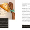 A hand with turquoise beaded bracelets lifts yellow paper with black paint from a gel plate—a scene from Gel Plate Printing for Mixed-Media Art by Schiffer Publishing, Ltd., which offers expert tips and cleaning methods for gel plate printing.
