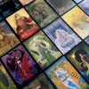 A spread of the Celtic Goddesses, Witches, and Queens Oracle by Schiffer Publishing, Ltd., features vibrant cards with mythological Celtic figures artfully arranged diagonally on a dark surface as a striking divination tool.
