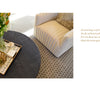 A cozy, striped armchair sits by a round dark coffee table topped with a tray of flowers, a book, and gold accents. On the right, a quote from Schiffer Publishing, Ltd.'s "It's All in the Mix" highlights the art of accessorizing.
