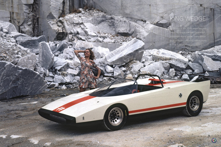 A woman in a floral dress stands on rocks behind an Alfa Romeo, featured by Schiffer Publishing, Ltd., parked in a stone quarry among marble slabs—a striking tribute to Italian automotive design.