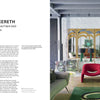 Interior Designers at Home by Schiffer Publishing, Ltd. showcases stylish living rooms with bold red chairs, a green sofa, vintage speakers, and a gold mirror—offering design inspiration against white brick walls and gray-blue beams.