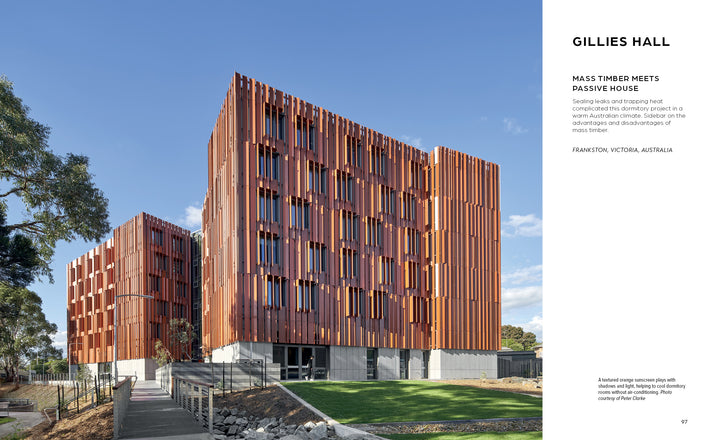 A modern commercial building with a bold rust-colored panel facade and large windows highlights the environmental benefits featured in "Innovations in Mass Timber" by Schiffer Publishing, Ltd., set amid trees, grass, and a welcoming entrance path.