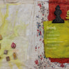 A fabric collage showcases "The Pigment Trail" by Schiffer Publishing, Ltd., featuring a yellow-green panel, floral fabric, a large flower Contents list, and small stamps inspired by Indian decorative arts on a lightly stained background.