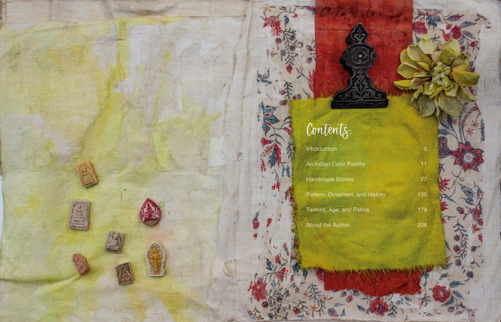 A fabric collage showcases "The Pigment Trail" by Schiffer Publishing, Ltd., featuring a yellow-green panel, floral fabric, a large flower Contents list, and small stamps inspired by Indian decorative arts on a lightly stained background.