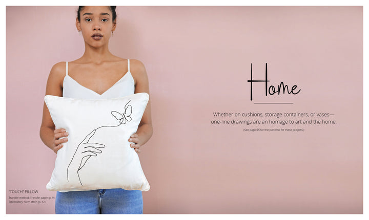 A woman in a white tank top holds the "Stitch with One Line" pillow by Schiffer Publishing, Ltd., featuring minimalist hand and butterfly embroidery—an inspiring project for beginners—against a pale pink background labeled "Home.