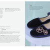 A pair of navy velvet Mary Jane shoes with pink floral embroidery—featured as a project in Stitch with One Line by Schiffer Publishing, Ltd.—rest on a white stool; embroidery instructions and shoe design tips appear on the left side.