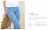 A person in light blue jeans featuring a minimalist white abstract face embroidery from "Stitch with One Line" by Schiffer Publishing, Ltd. holds a wicker chair. Text highlights beginner embroidery projects to personalize your jeans.