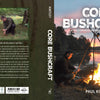 Core Bushcraft by Schiffer Publishing, Ltd. features a cover of a man by a lakeside campfire at sunset, with icons for woodcraft, bindcraft, firecraft, and sheltercraft—highlighting this true outdoor survival guide.