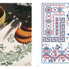 A cup of tea and cookies rest on a white cloth, beside "Vintage French Needlework" by Schiffer Publishing, Ltd.—a chart with red and blue vintage French floral and geometric embroidery patterns.