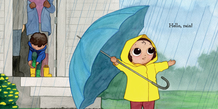 A cheerful child in a yellow raincoat holds a blue umbrella and smiles, while another puts on yellow boots by the door, with an adult nearby. "Hello, Rain!" by Schiffer Publishing, Ltd. is the perfect rainy day board book for nature-loving kids.