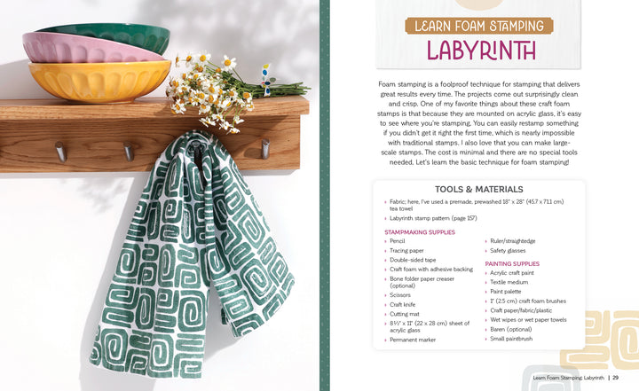 A green and white tea towel, crafted with the Fabric Stamping technique from Schiffer Publishing, Ltd., hangs on a wooden rack beside stacked bowls and daisies. Foam stamp printing instructions appear to the right.