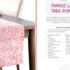 A pink and white fanned leaf table runner made with Fabric Stamping by Schiffer Publishing, Ltd. rests on a wooden table with red apples, while a book page lists materials, tools, and instructions for making the runner.