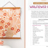 A framed floral wall art featuring pink, orange, and cream flowers in a striped vase is displayed beside Schiffer Publishing, Ltd.'s Fabric Stamping supplies and instructions for a custom wallflower hanging art project using foam stamping techniques.