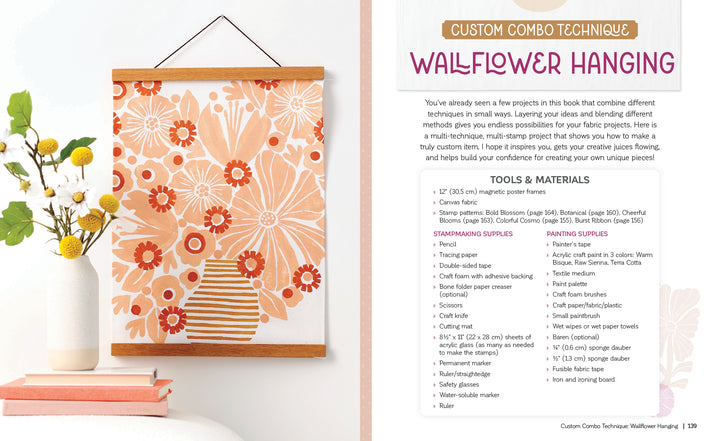 A framed floral wall art featuring pink, orange, and cream flowers in a striped vase is displayed beside Schiffer Publishing, Ltd.'s Fabric Stamping supplies and instructions for a custom wallflower hanging art project using foam stamping techniques.
