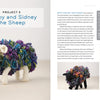 A Swatch Critters from the Pin Loom stuffed sheep with a white head, legs, and tail and a colorful, textured body stands on a white surface. Instructions and materials by Schiffer Publishing, Ltd. are shown on the right side of the page.