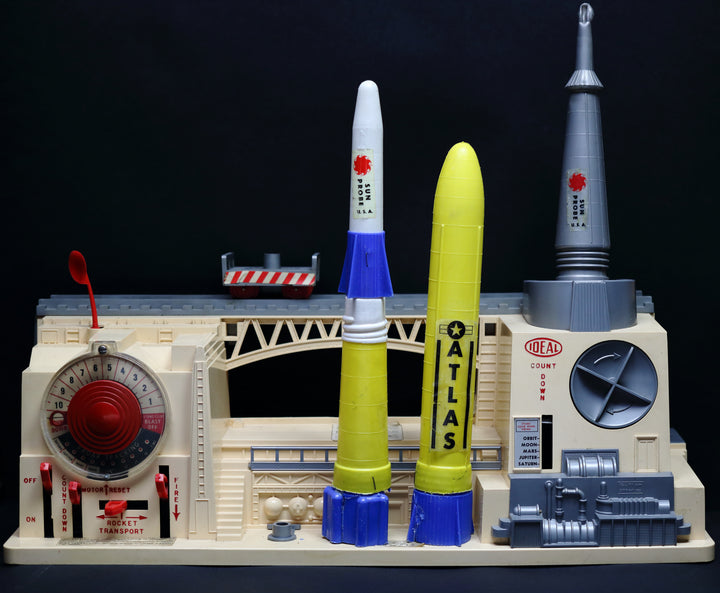 The "Model Rocketry" by Schiffer Publishing, Ltd. stands out against a black background, evoking the spirit of vintage space flight and the golden age of model rockets.