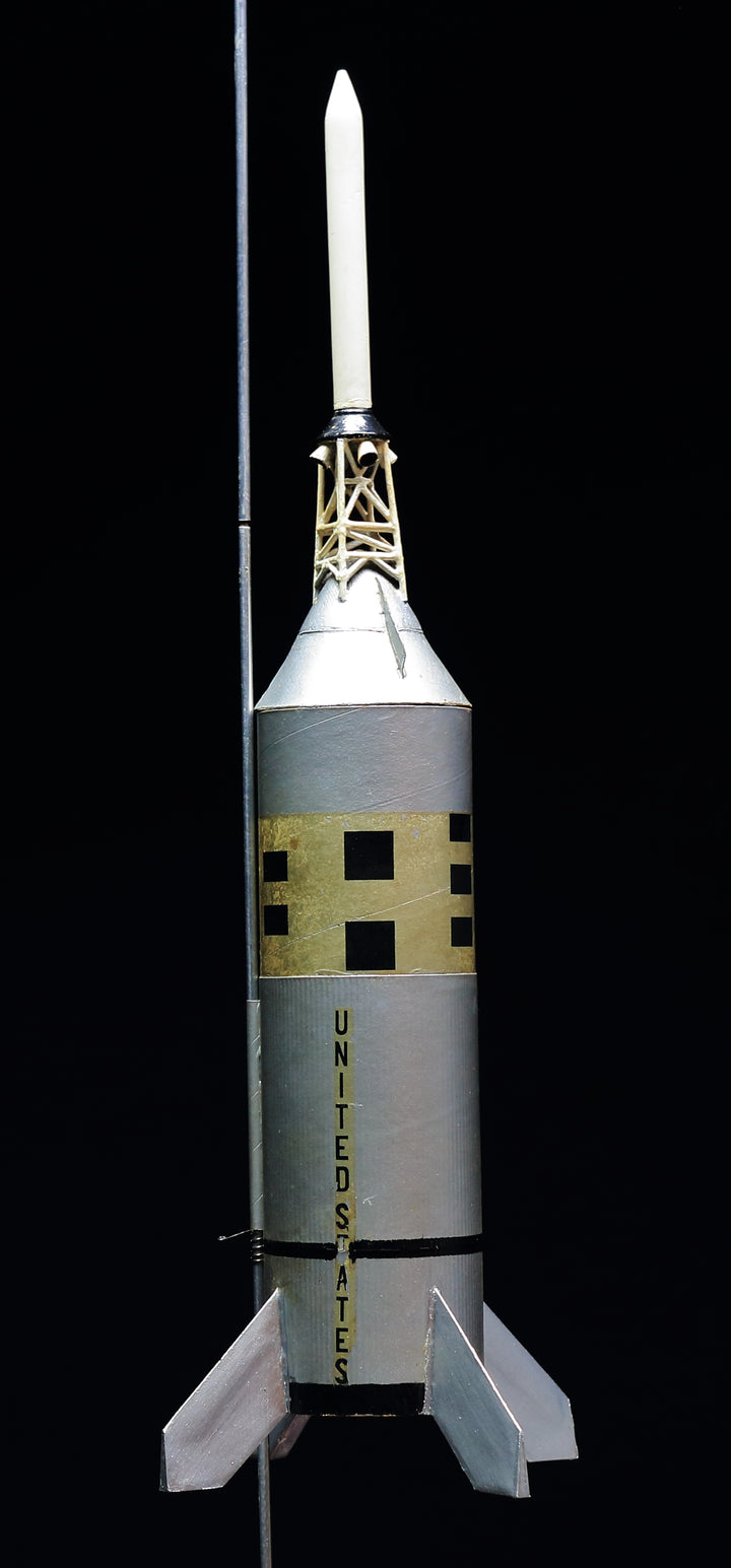 The "Model Rocketry" by Schiffer Publishing, Ltd. features a vintage silver rocket with black and yellow checks, base fins, and UNITED STATES along the side—evoking the golden age of space flight against a black backdrop.