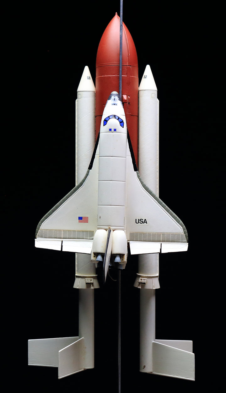 The Schiffer Publishing, Ltd. Model Rocketry features a vintage NASA space shuttle model with orbiter, white solid rocket boosters, and orange external fuel tank mounted vertically against a black background—celebrating the golden age of space flight.