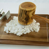 The Japanese Paper Yarn by Schiffer Publishing, Ltd. is shown being pressed with a wooden mallet and meat tenderizer onto white dough or cheese on a wooden board, reflecting traditional craft techniques.