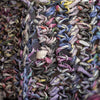 Close-up of thick, textured loops made from Schiffer Publishing, Ltd.'s Japanese Paper Yarn in vibrant purple, blue, yellow, and pink—showcasing colorful modern fiber craft with loosely woven strips.