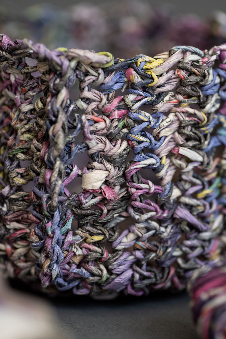 Close-up of thick, textured loops made from Schiffer Publishing, Ltd.'s Japanese Paper Yarn in vibrant purple, blue, yellow, and pink—showcasing colorful modern fiber craft with loosely woven strips.
