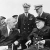 Franklin D. Roosevelt and Winston Churchill sit together, smiling, while two notable US Navy officers stand behind them during a WWII event—an image featured in "King's Navy" by Schiffer Publishing, Ltd.