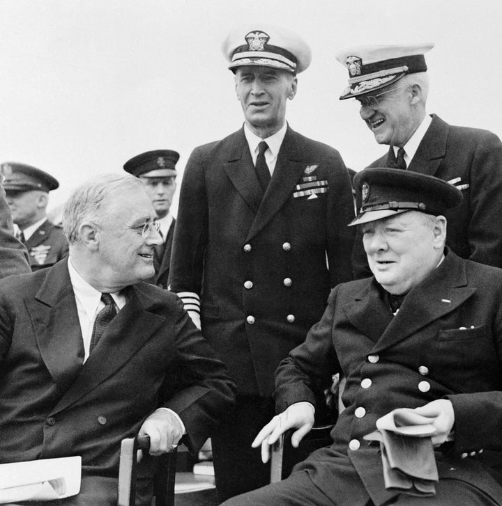 Franklin D. Roosevelt and Winston Churchill sit together, smiling, while two notable US Navy officers stand behind them during a WWII event—an image featured in "King's Navy" by Schiffer Publishing, Ltd.