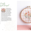 Cozy Stitches by Schiffer Publishing, Ltd. features a stitched bouquet of pink and yellow flowers with green stems on pink gingham—ideal for embroidery or slow stitching. A vase with matching real flowers and supply lists is also pictured.