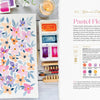 The Modern Watercolor Workshop by Schiffer Publishing, Ltd. features a vibrant watercolor painting with pink, orange, and purple flowers on a table with palettes, brushes, a candle, and water—ideal for beginner creative projects.