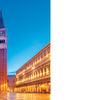 A view of St Mark’s Square in Venice at dusk, with the basilica and bell tower aglow, lights reflecting on wet pavement—perfect for any Venice photo book like "Doors of Venice" from Schiffer Publishing, Ltd.